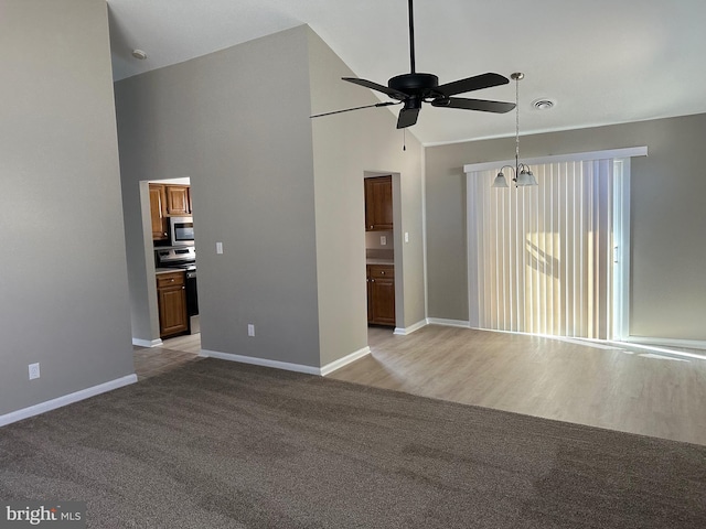 unfurnished room featuring light wood-type flooring and ceiling fan with notable chandelier