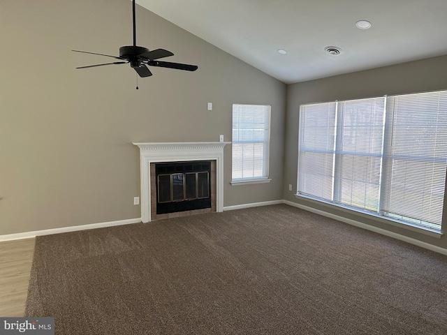 unfurnished living room with ceiling fan, carpet flooring, and high vaulted ceiling