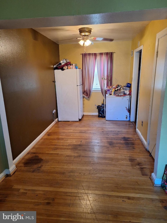 laundry area featuring wood-type flooring and ceiling fan