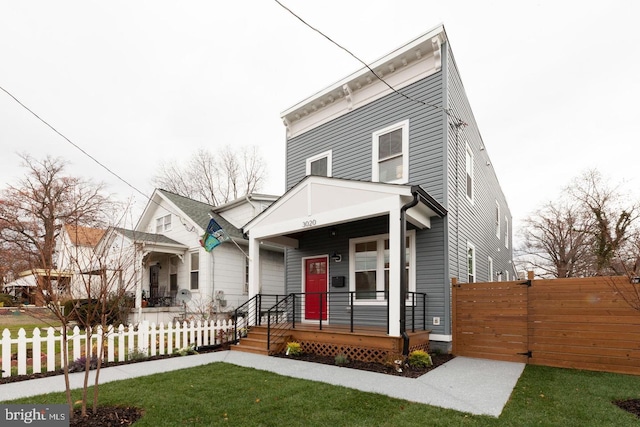 view of front of home with a porch and a front yard