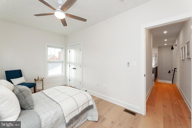 bedroom with ceiling fan and light hardwood / wood-style floors