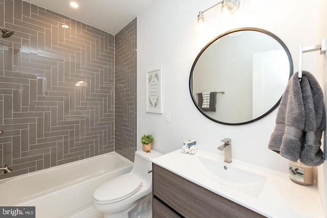 full bathroom with tiled shower / bath, vanity, and toilet