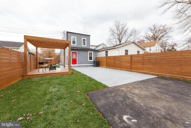 view of yard with central AC unit and a patio