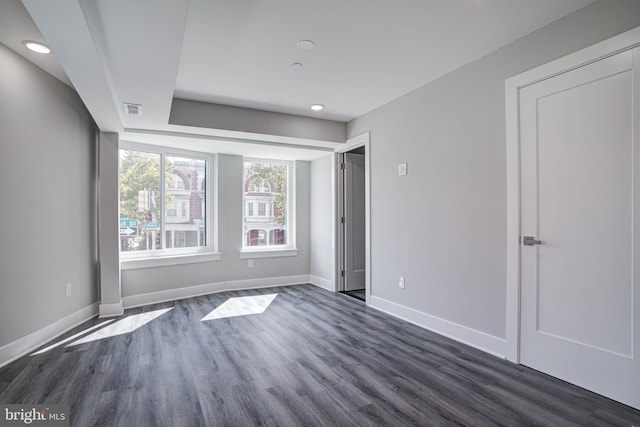 unfurnished bedroom with dark wood-type flooring