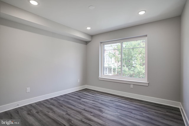 spare room with dark wood-type flooring