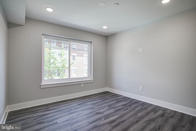 empty room with dark hardwood / wood-style flooring