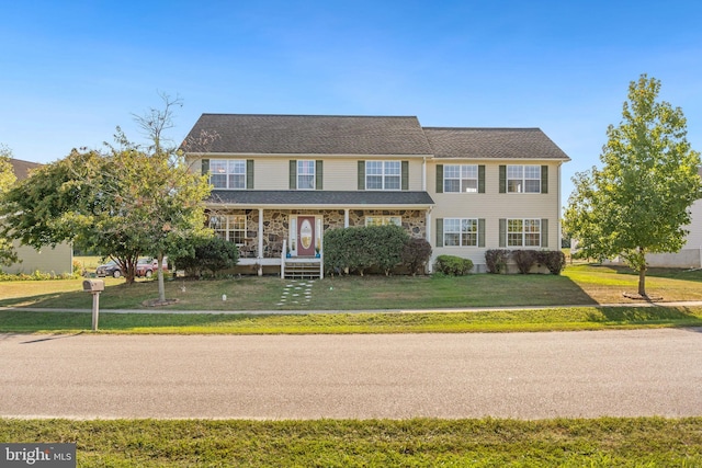 view of front of home featuring a front yard and stone siding