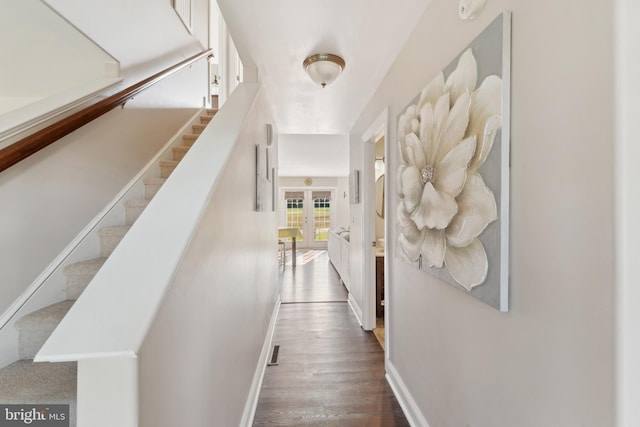 hallway with dark hardwood / wood-style flooring