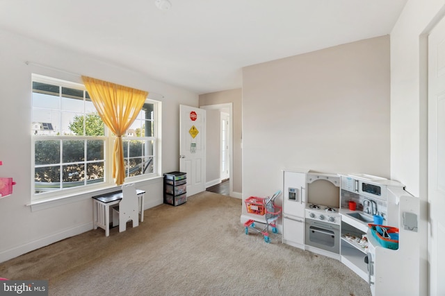 playroom featuring light colored carpet and sink