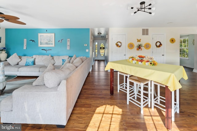 living room with ceiling fan and dark hardwood / wood-style floors