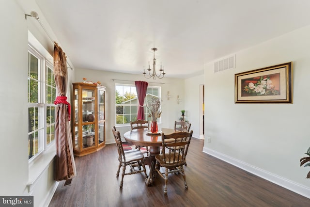 dining room with visible vents, baseboards, dark wood-style floors, and a chandelier