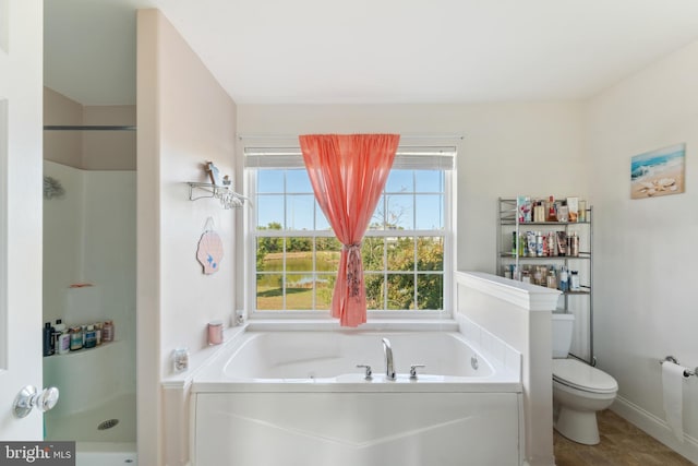 bathroom with toilet and shower with separate bathtub