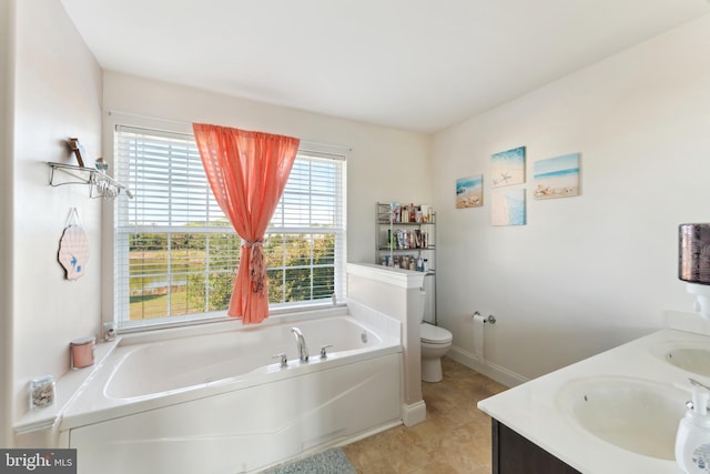 bathroom with vanity, toilet, a bath, and tile patterned floors