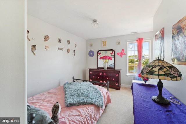 bedroom with light colored carpet