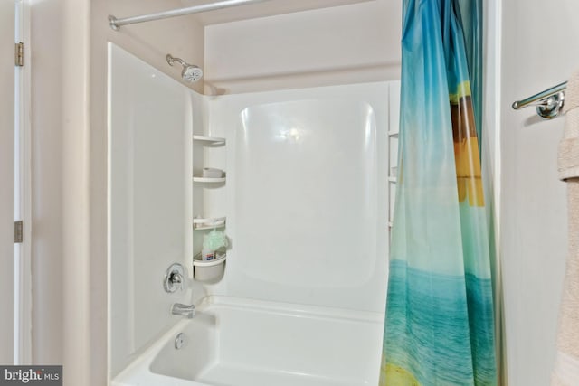 bathroom featuring shower / tub combo with curtain