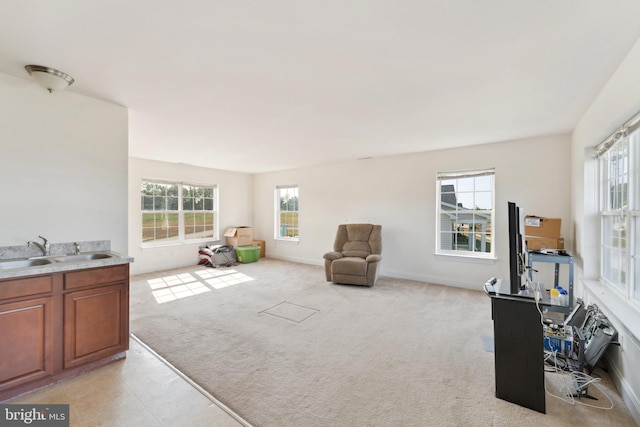 carpeted living room featuring sink