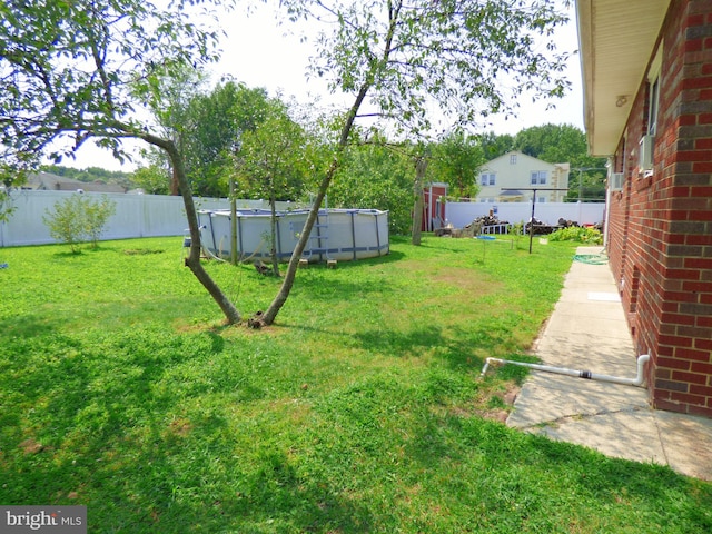 view of yard with a fenced in pool