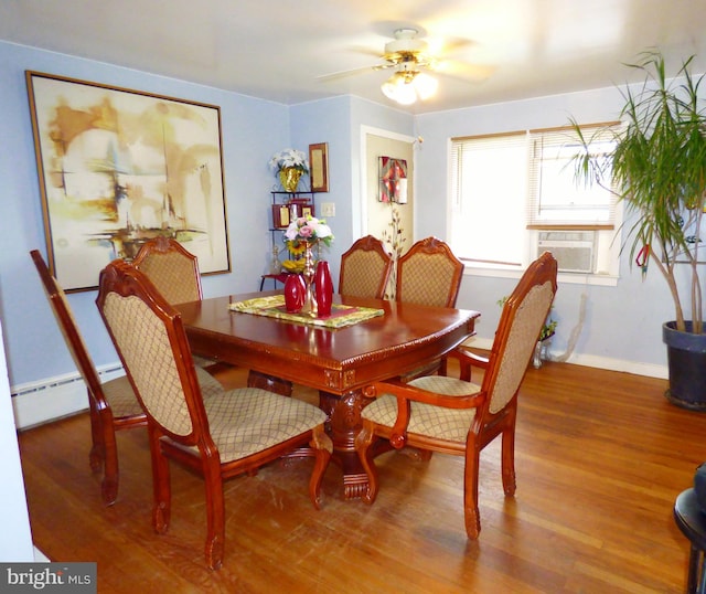 dining room with a baseboard heating unit, ceiling fan, hardwood / wood-style floors, and cooling unit