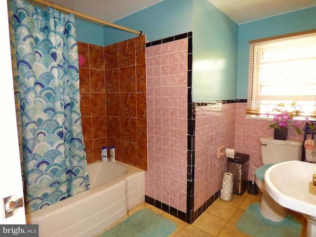 bathroom featuring tile walls, tile patterned flooring, toilet, and shower / bath combination with curtain