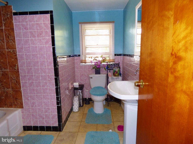 bathroom featuring tile walls, toilet, and tile patterned floors