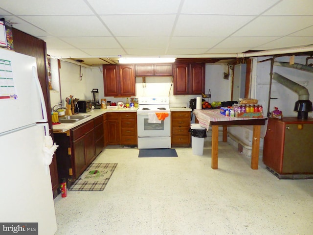 kitchen with white appliances, a paneled ceiling, and sink