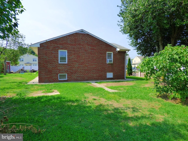 rear view of house featuring a yard