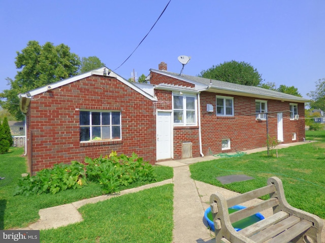 rear view of property with a yard