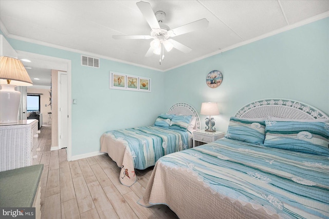 bedroom with ceiling fan, crown molding, and light hardwood / wood-style floors