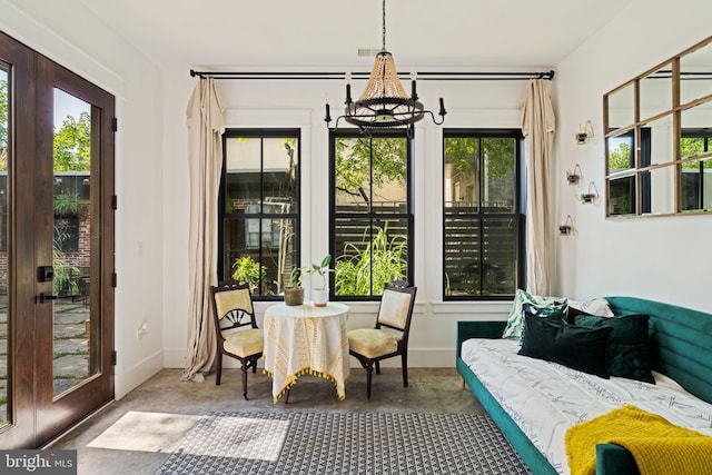 sunroom / solarium with a chandelier