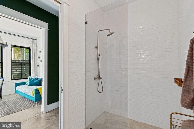 bathroom featuring concrete flooring and a tile shower