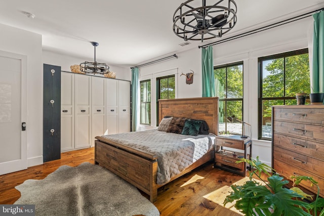 bedroom with a closet and light hardwood / wood-style floors