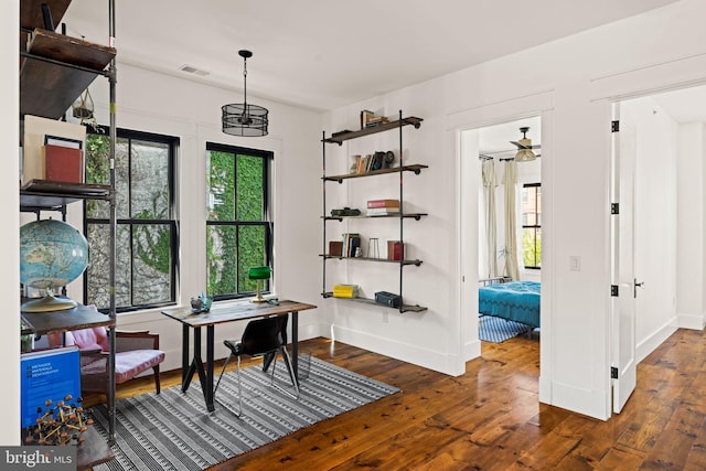 office area featuring a chandelier and dark hardwood / wood-style flooring