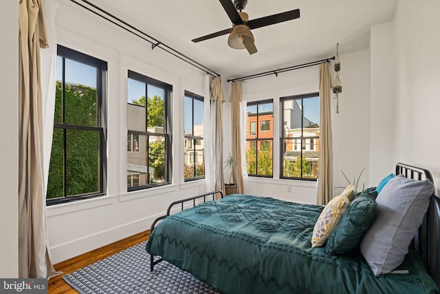 bedroom with ceiling fan and hardwood / wood-style flooring