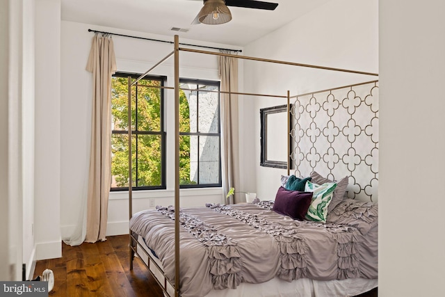 bedroom featuring multiple windows, ceiling fan, and dark hardwood / wood-style flooring