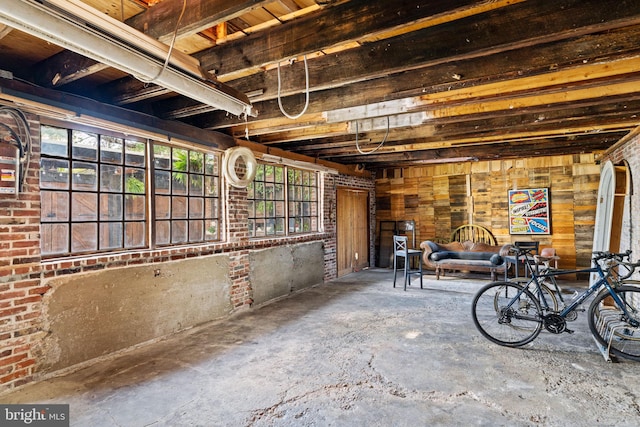 basement with a healthy amount of sunlight and wood walls