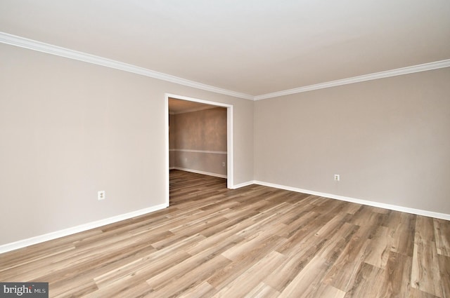 spare room with light hardwood / wood-style flooring and ornamental molding