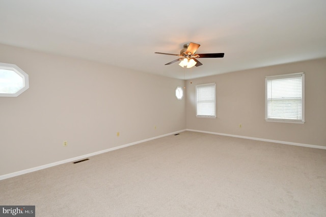 unfurnished room with ceiling fan and light colored carpet