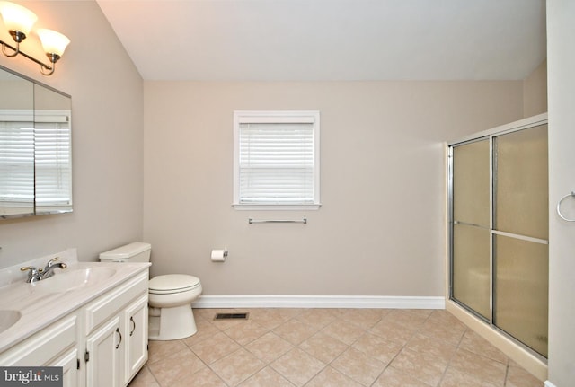 bathroom featuring walk in shower, vanity, tile patterned flooring, and toilet