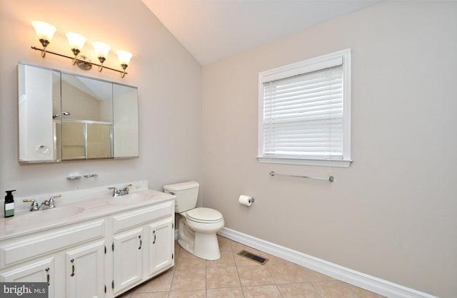 bathroom featuring vanity, tile patterned flooring, vaulted ceiling, walk in shower, and toilet