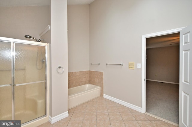 bathroom with independent shower and bath and tile patterned flooring