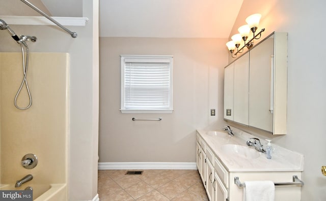 bathroom with vanity, tile patterned flooring, and  shower combination