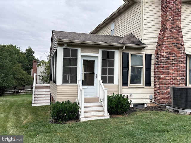 exterior space featuring a lawn and central air condition unit