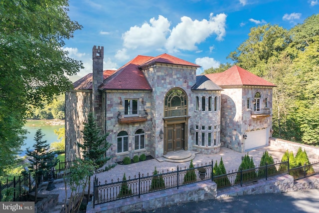 view of front of home featuring a garage and a water view