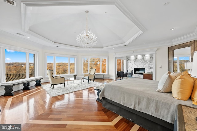 bedroom featuring ornamental molding, a notable chandelier, multiple windows, and a high end fireplace