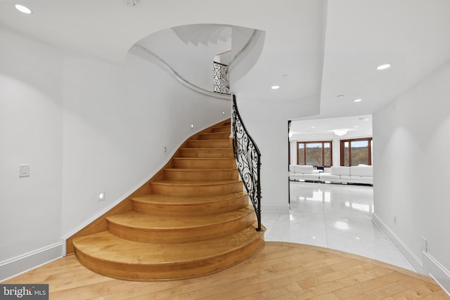 stairway featuring wood-type flooring