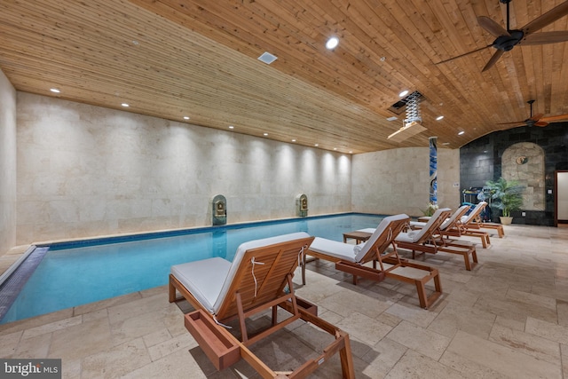 view of pool with ceiling fan and a jacuzzi