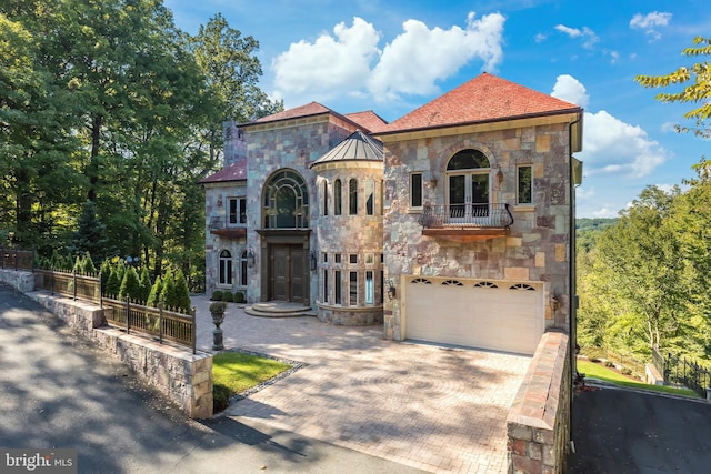 mediterranean / spanish home featuring a garage