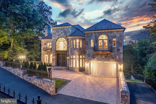 view of front of home featuring a garage and a balcony