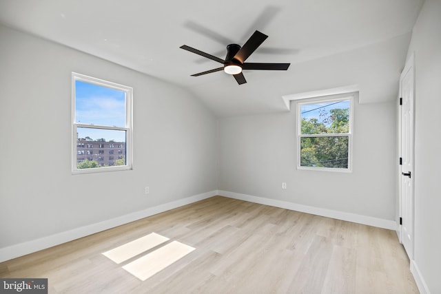 additional living space with ceiling fan, light hardwood / wood-style flooring, lofted ceiling, and a healthy amount of sunlight