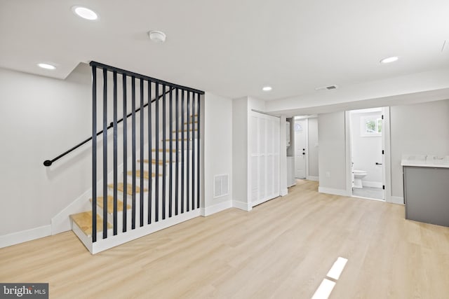 stairway with hardwood / wood-style flooring